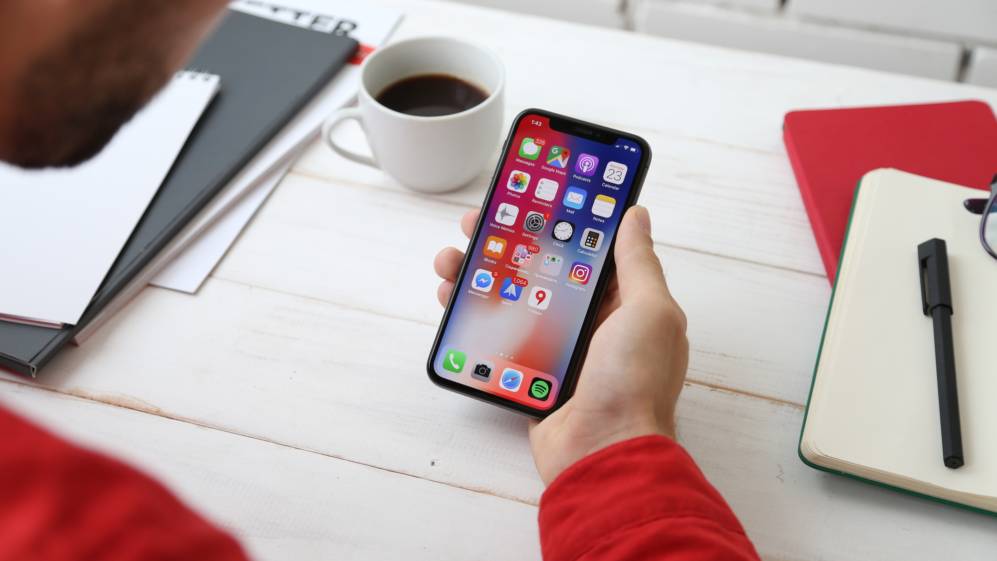 Person using phone at white desk